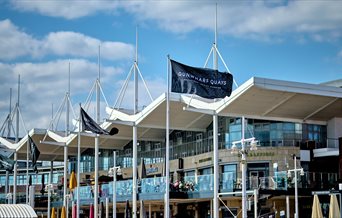 A Gunwharf Quays flag flying near the centre's restaurants