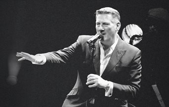 Black and white photograph of Tony Hadley mid-performance