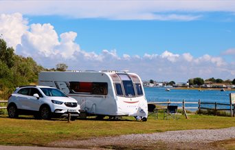 Caravan pitch overlooking the water at Fishery Creek Park