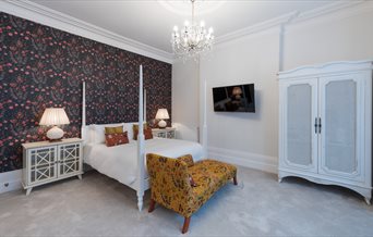 Modern four-poster bed in a room at The Clarence Boutique Rooms