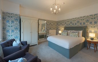 A double room with additional seating options at Florence House Boutique Hotel and Restaurant