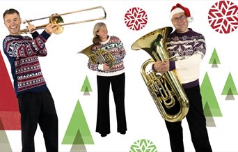 Three performers from the Bournemouth Symphony Orchestra with their instruments and Christmas jumpers
