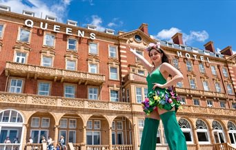 Woman in green outside the Queens Hotel