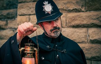 Image for Mystery at Fort Nelson showing a costumed police officer holding up a lamp