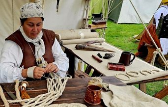 Sarah Liscoe making a historical sail using traditional techniques