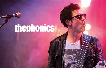 Poster for The Phonics, showing the lead singer mid-performance