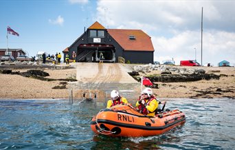 Photograph of a lifeboat heading out of the RNLI station at Eastney