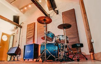 Photograph of Room 2 at Southsea Sound, with the Natal drum kit set up and amps ready