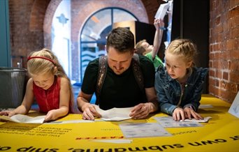 A dad and children enjoying a day out at Portsmouth Historic Dockyard