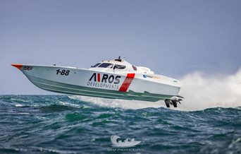 Photograph of a boat racing over the water - by Snap Photography