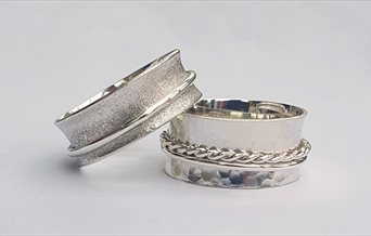 Two silver spinner/worry rings