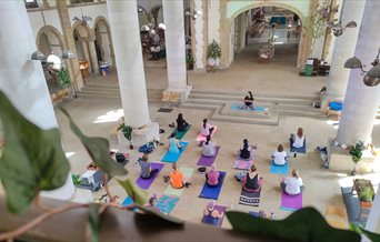 A group of people taking part in a yoga class at Portsmouth Cathedral.