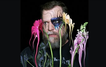 Picture of singer John Grant with flowers.