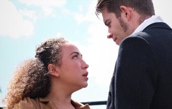A man and woman from a production of Pride and Prejudice.