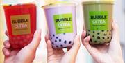 Three cups of Bubble Ci-Tea held aloft