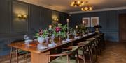 Dining room at Queens Hotel with a long wooden dining table