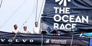 Sailors on a boat with the Ocean Race logo featuring on a sail, copyright Sailing Energy - The Ocean Race