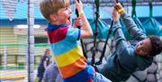 Young boys on swings at Exploria in Southsea