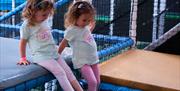 Young girls testing out the bounce and climb activities in Exploria