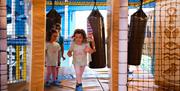 Children running through the activities inside Exploria