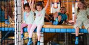 Children enjoying the climbing activities at Exploria