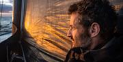A sailor looks out over the sea at sunset, copyright Antoine Auriol - Team Malizia - The Ocean Race