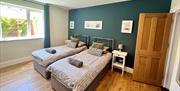 Twin beds at The Beach at the End of the Road - The garden apartment