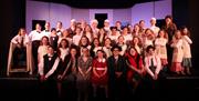 A cast of children on stage for a performance of Annie at the Groundlings Theatre