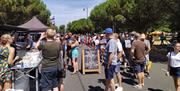 People enjoying sunny weather and food along Avenue de Caen for Southsea Food Festival