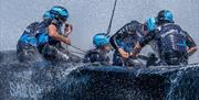 Sailors battling the elements during a SailGP race