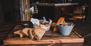 A selection of snacks available at the bar including sandwiches, cheese and olives.