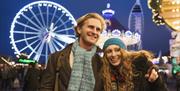 A couple enjoying the Christmas Village at Gunwharf Quays