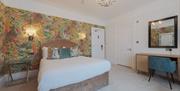 A double bed and writing desk at Florence Gardens Boutique Hotel and Restaurant