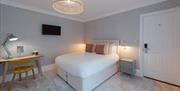 A double room with writing desk at The Clarence Boutique Rooms