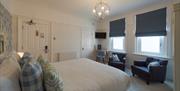 A double bedroom with comfy seating at Florence House Boutique Hotel and Restaurant
