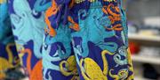 Swim shorts with a multi-coloured octopus design