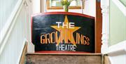 Staircase at the Groundlings Theatre with a painted board at the top