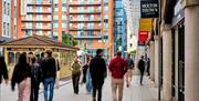 Shoppers walking around Gunwharf Quays