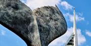 Close-up detail on the whale tail sculpture