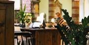 Tables set up for work at The Host Coworking Space in St Luke's Church