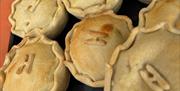 A collection of pies for sale at a farmers market in Southsea