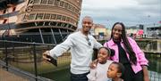 Family taking a selfie outside HMS Victory