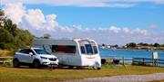 Caravan pitch overlooking the water at Fishery Creek Park