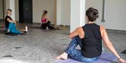 Stretching during a Yoga class at LANO Yoga in Southsea