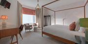 A modern four-poster bed in a room at Florence Suite Boutique Hotel and Restaurant