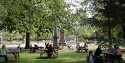 People enjoying the benches at Victoria park