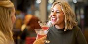 Two women enjoying cocktails at one of Port Solent's bars