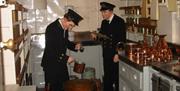 Photograph of measuring the tot on HMS Belfast
