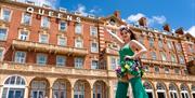 Woman in green outside the Queens Hotel