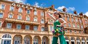 Woman in green outside the Queens Hotel